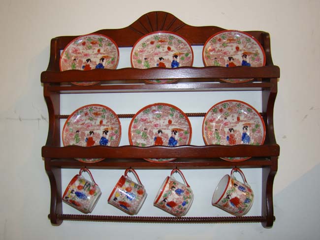 A charming miniature plate rack holding four 19th century Japanese demitasse cups and six saucers